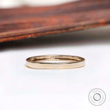 Front view of plain polished yellow gold wedding band