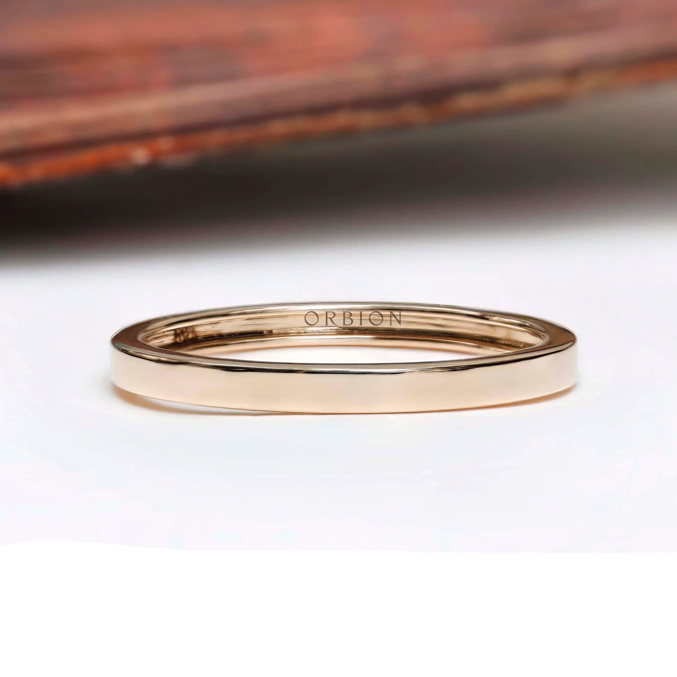 Front view of plain polished yellow gold wedding band