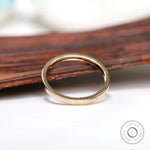 Angled view showing smooth flat gold band profile