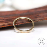 Angled view showing smooth flat gold band profile
