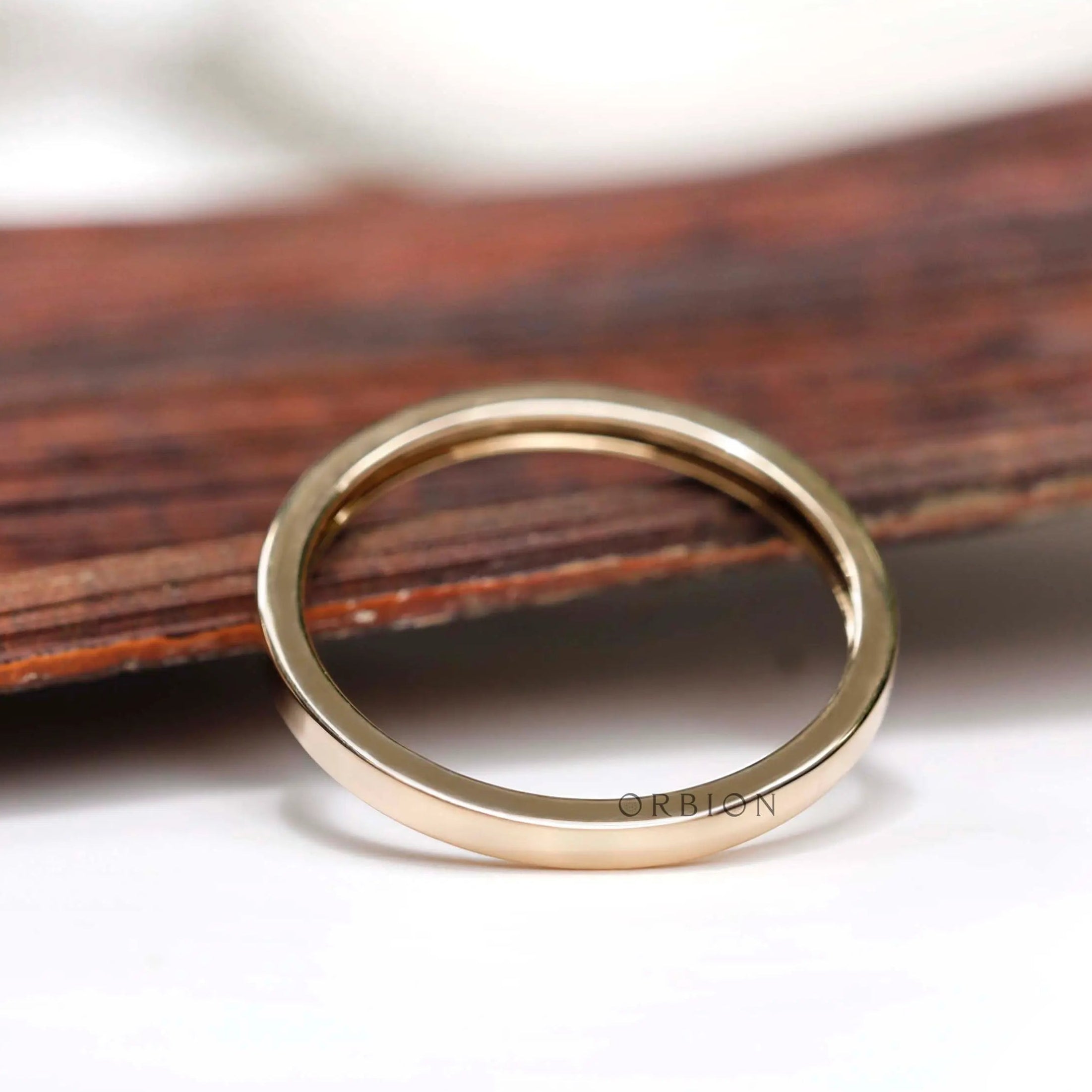Angled view showing smooth flat gold band profile