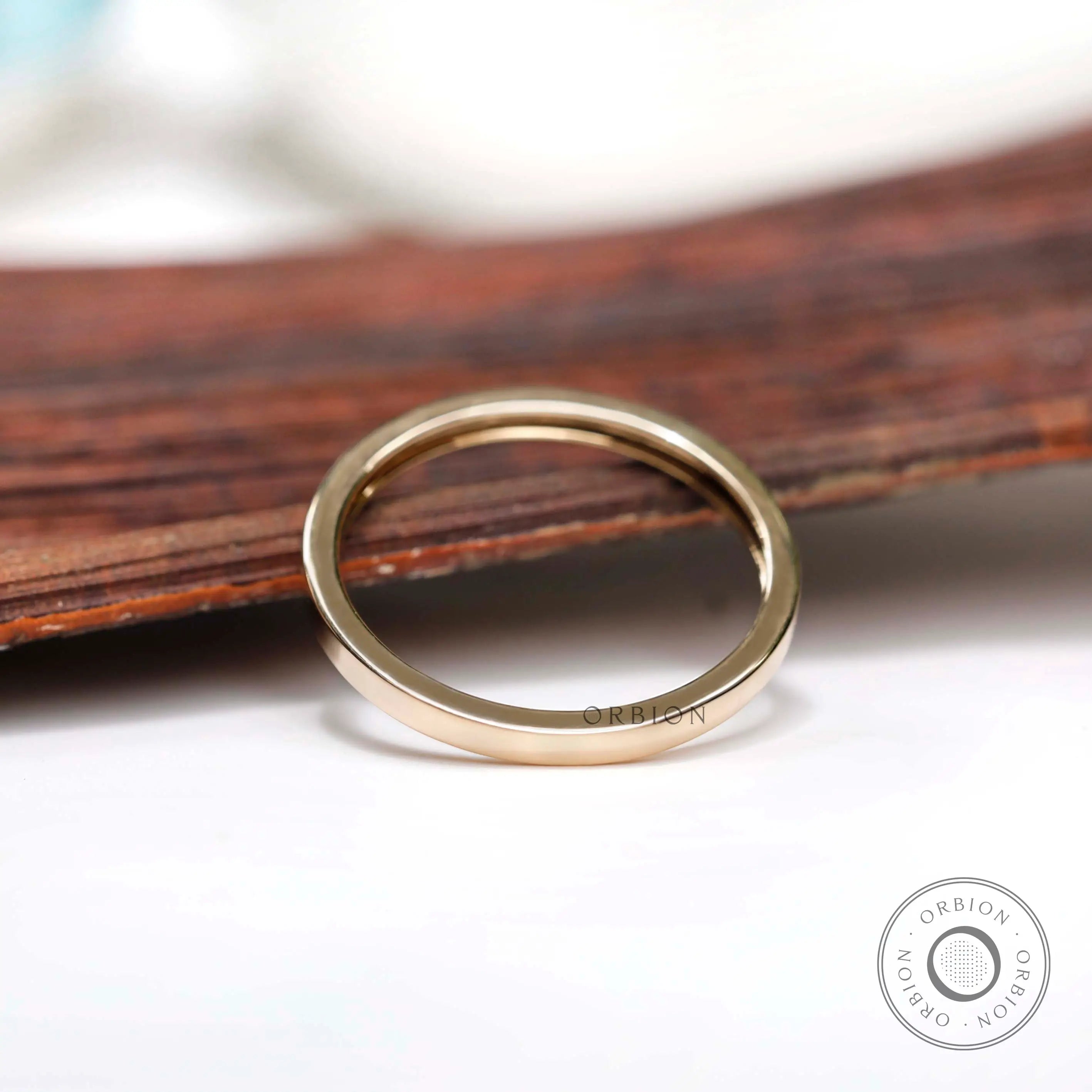 Angled view showing smooth flat gold band profile