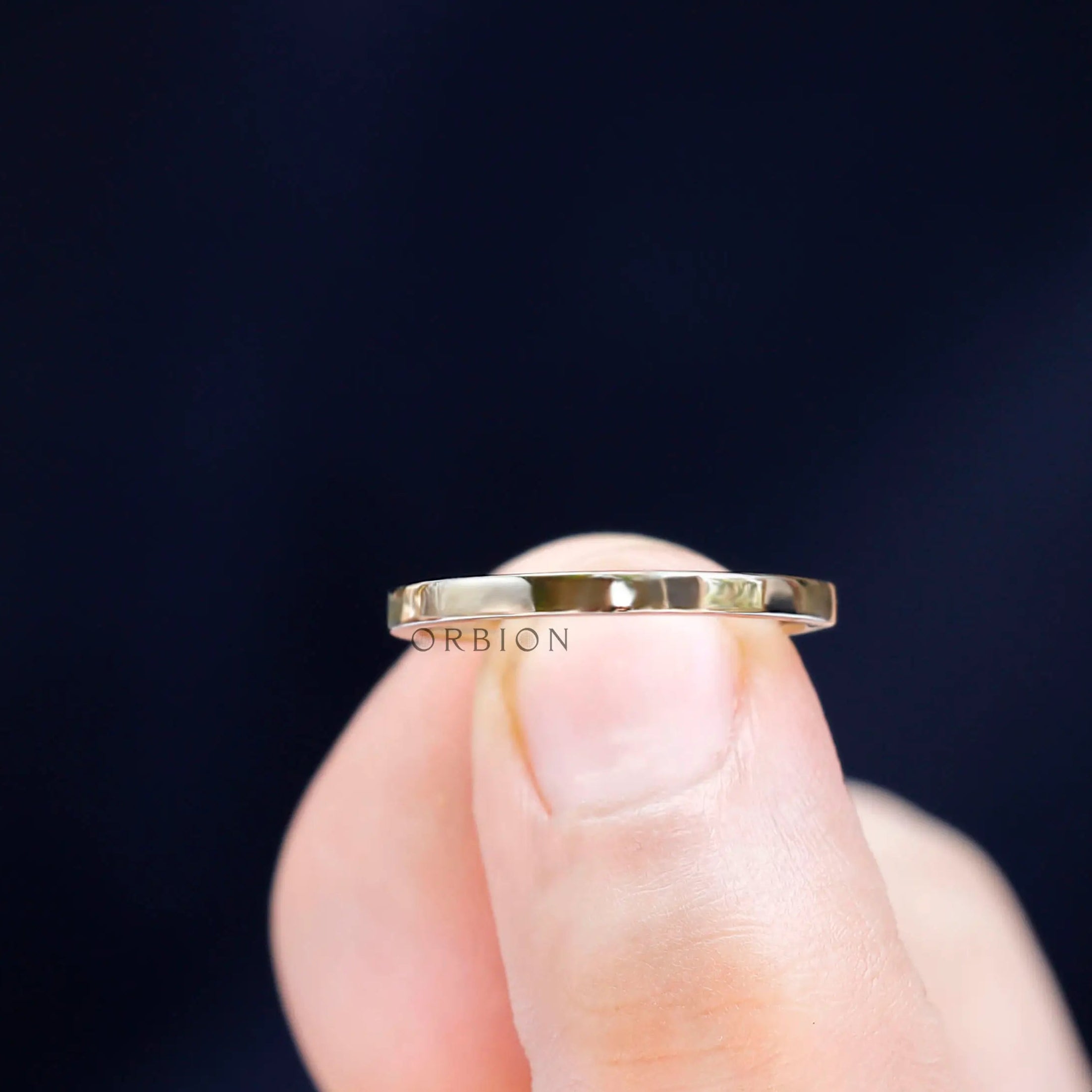 Close-up of high polish finish on plain gold band