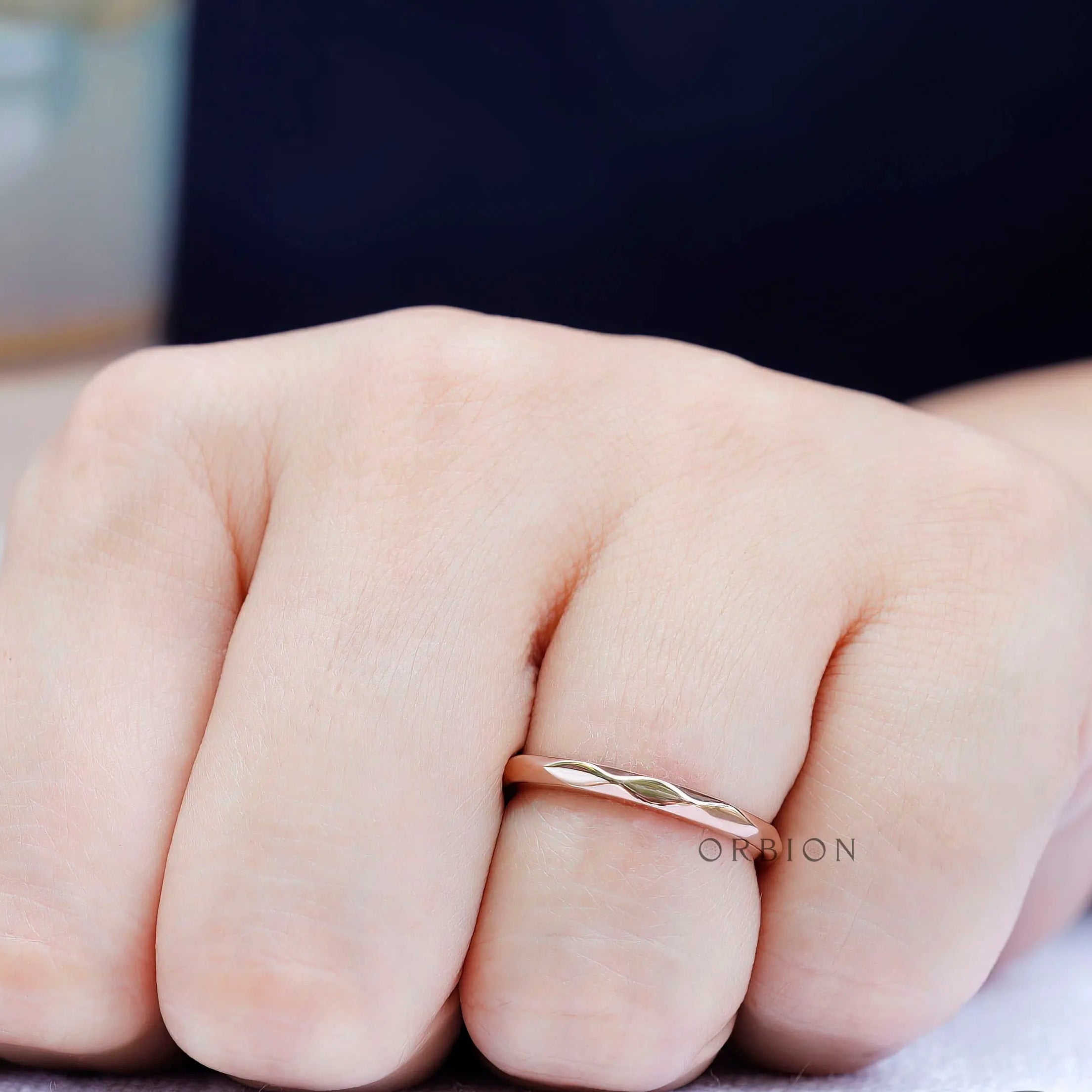 Close-up highlighting hammered facets on rose gold band