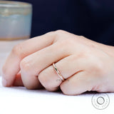 On-hand view of minimalist hammered rose gold band