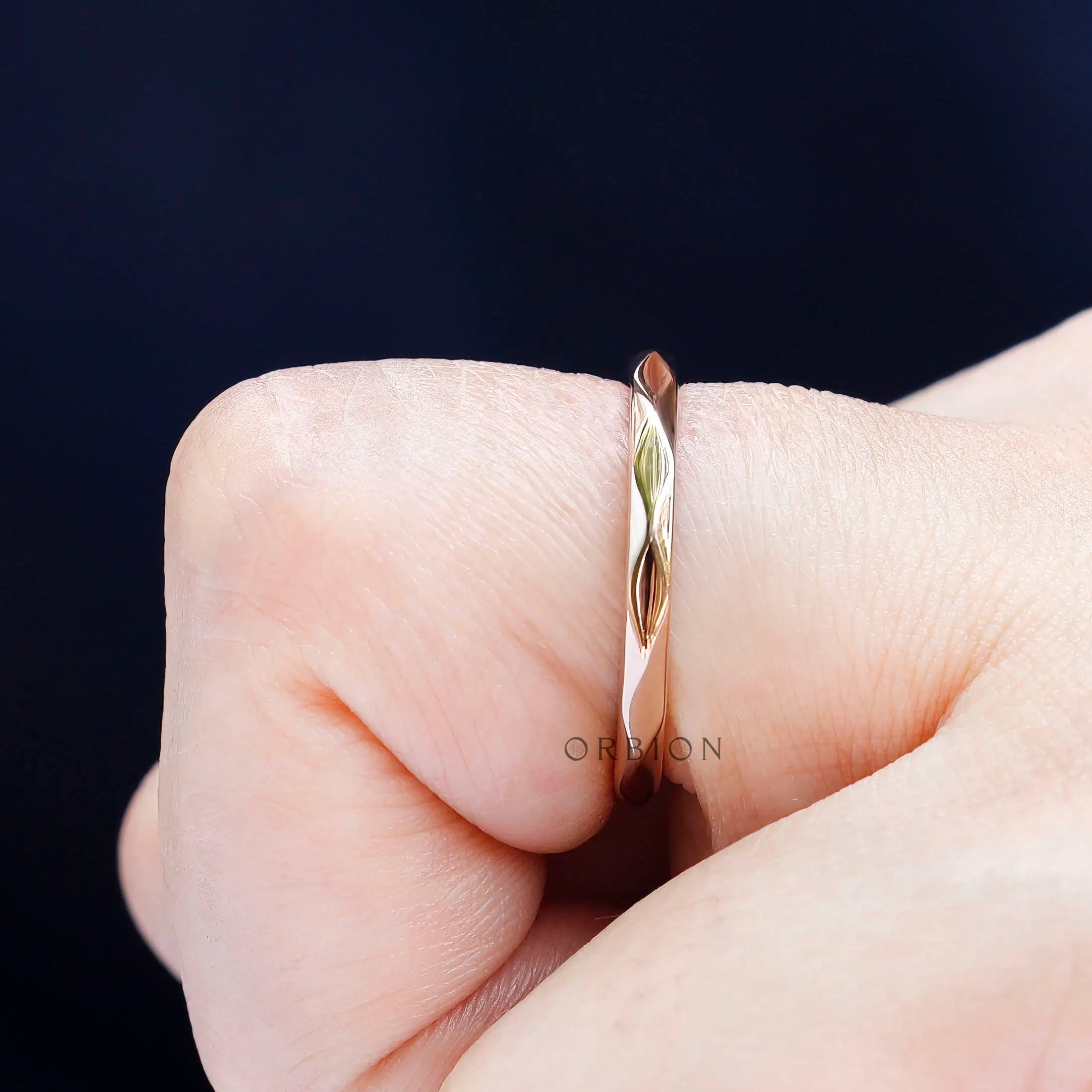 Side angle on-hand showing slim hammered profile