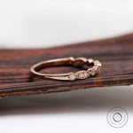Rose gold Art Deco marquise and round band showing delicate milgrain