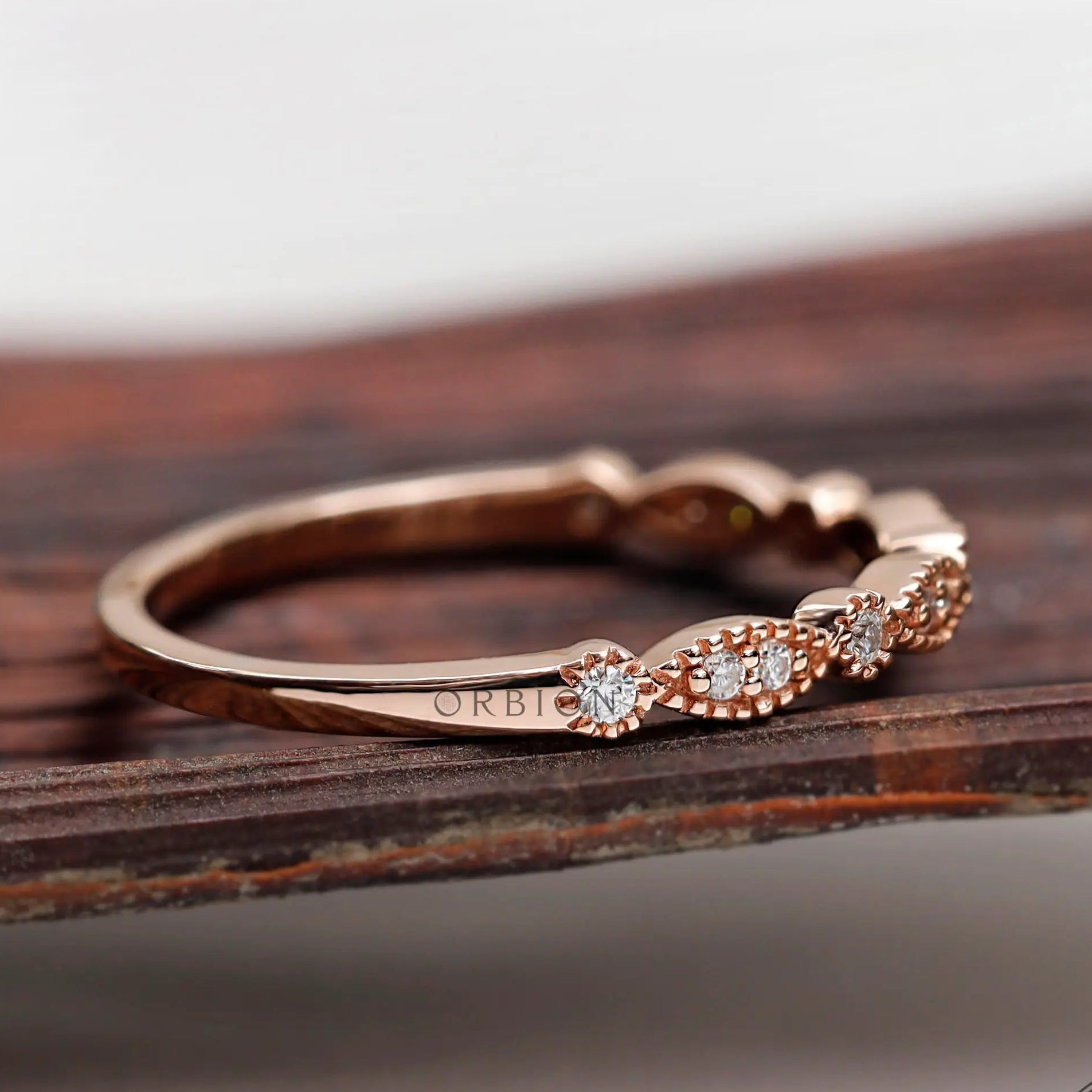 Rose gold Art Deco marquise and round band showing delicate milgrain
