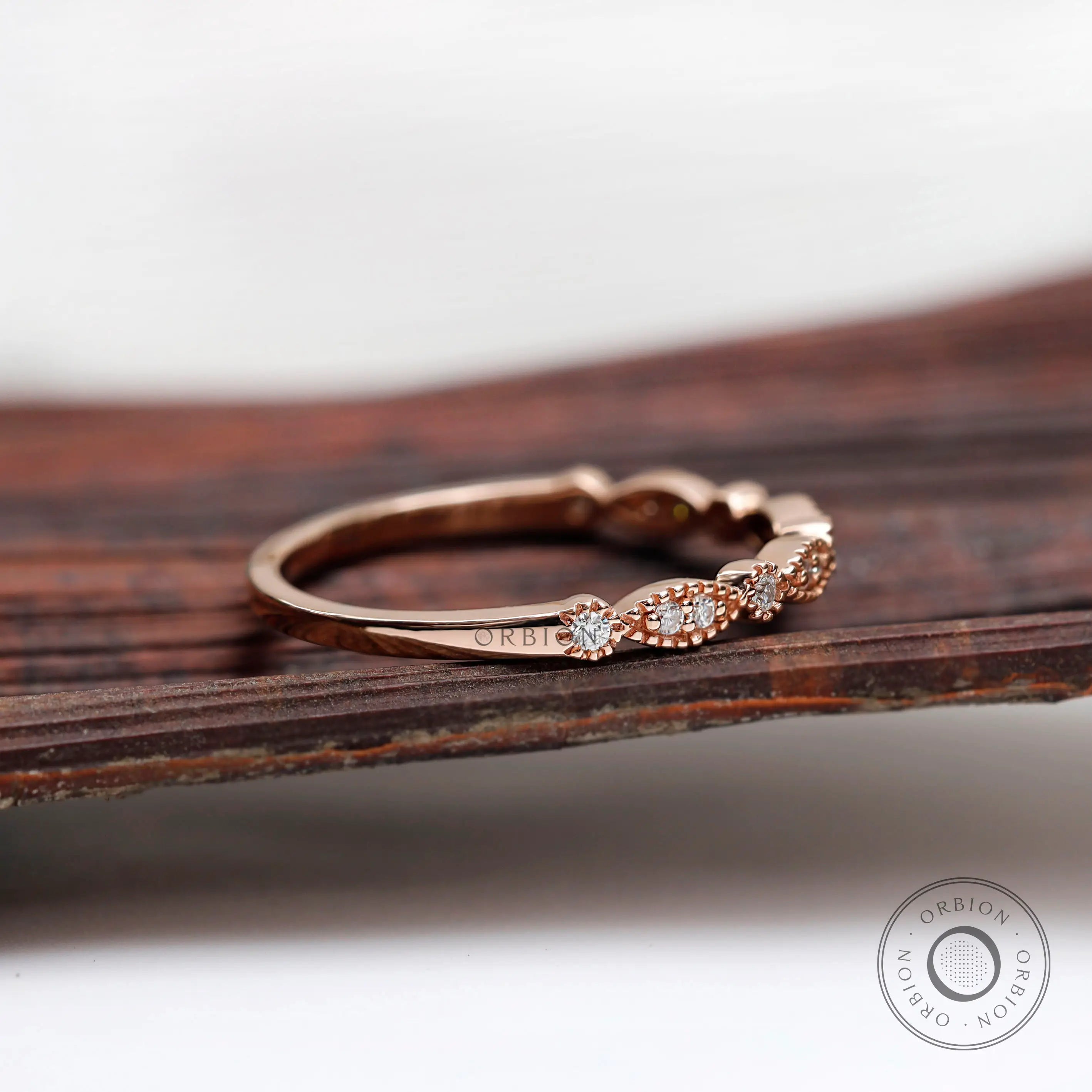 Rose gold Art Deco marquise and round band showing delicate milgrain