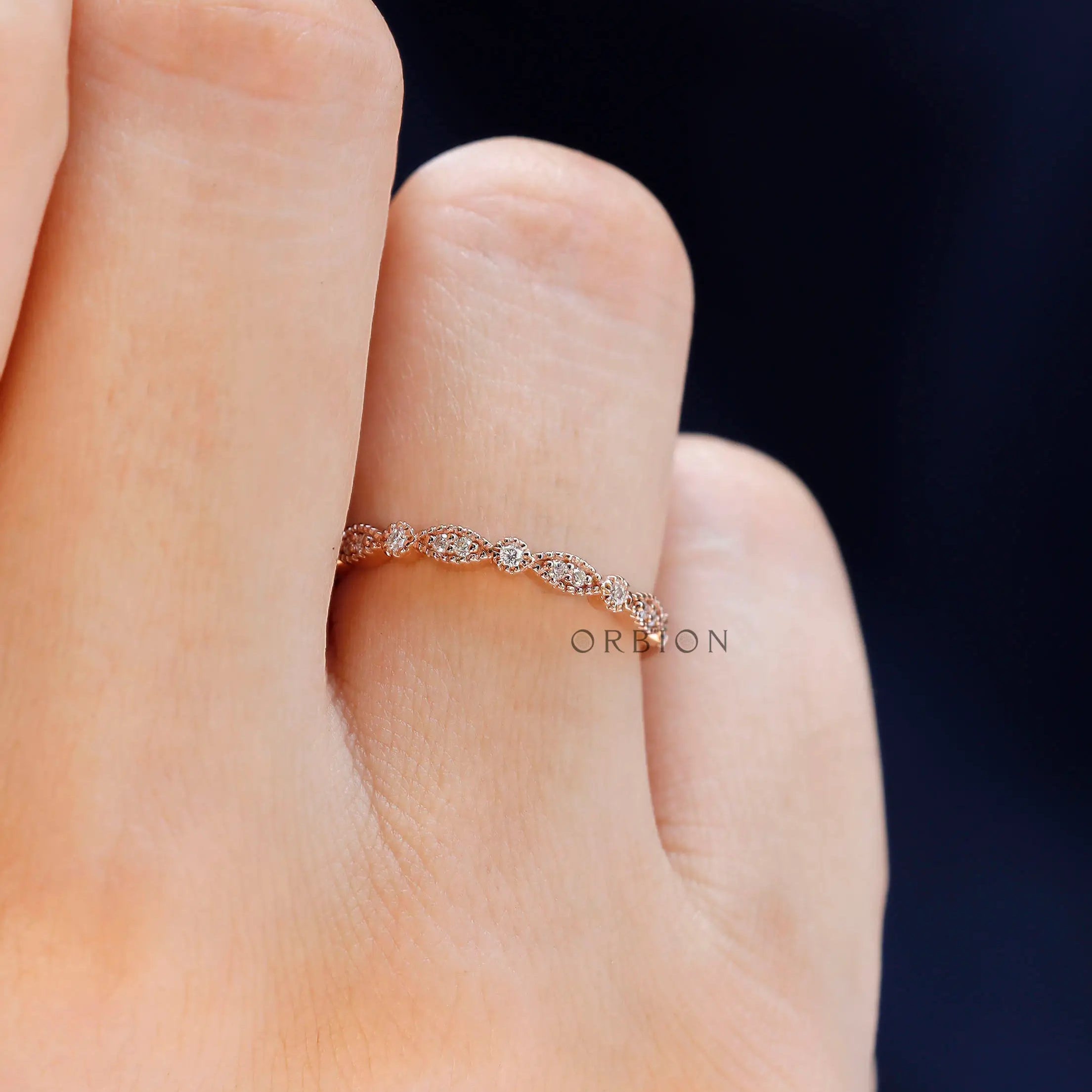Vintage Art Deco marquise and round moissanite band styled on hand