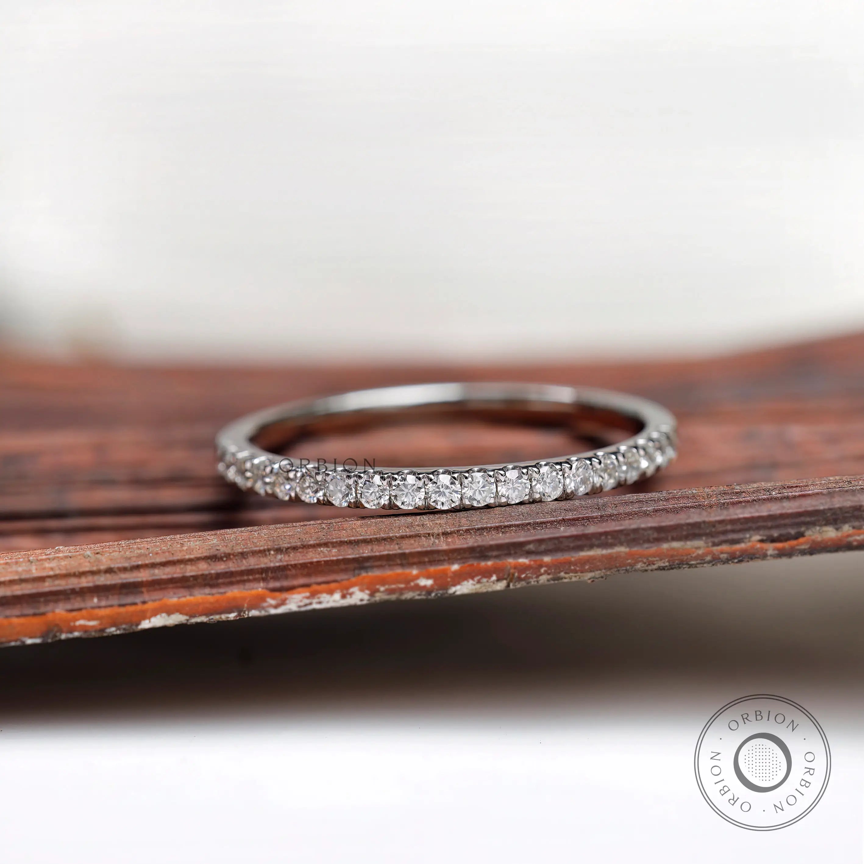 Front close-up of pave set round stones on dainty wedding band