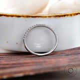 Side view of minimalist pave wedding band highlighting slim profile