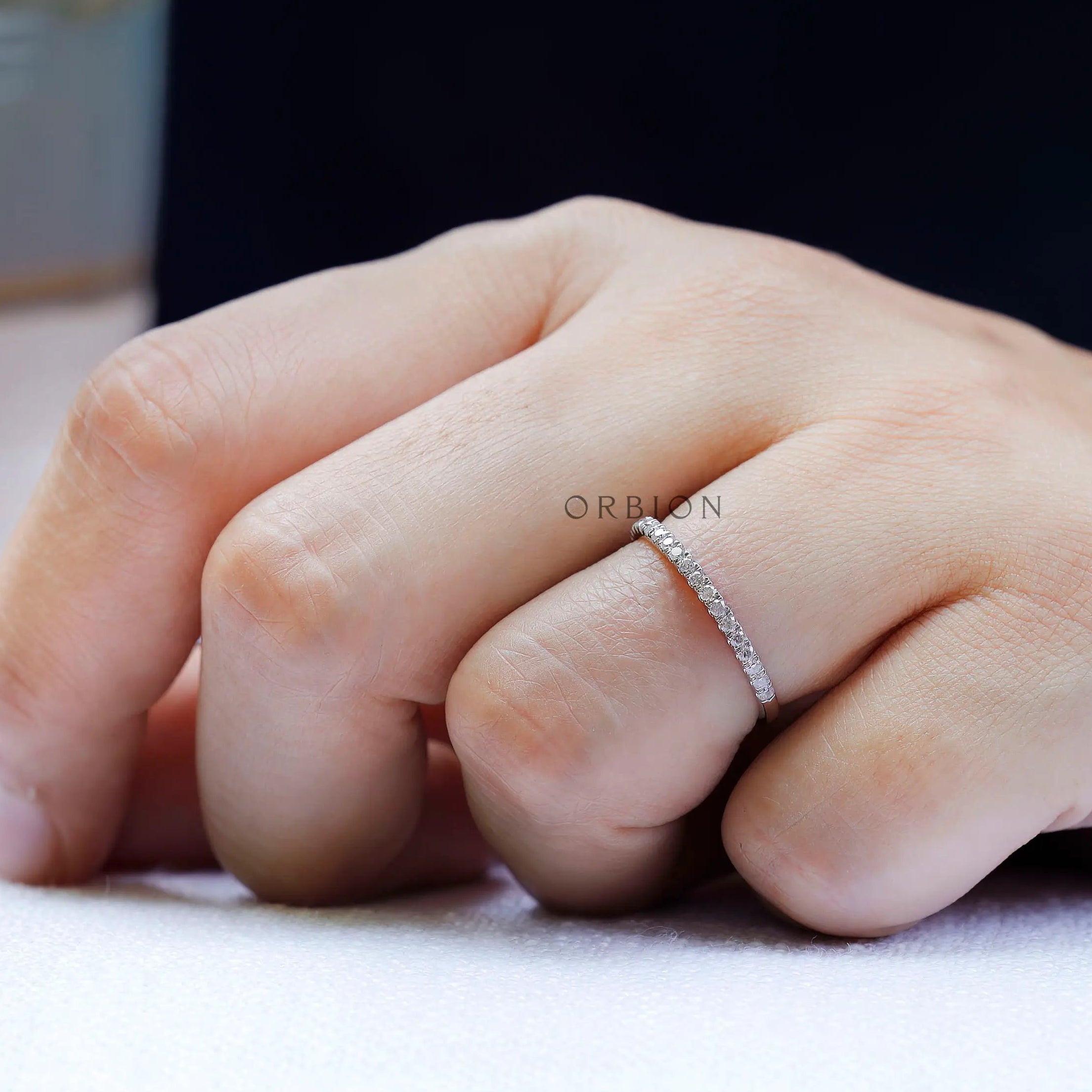 On hand view minimalist pave moissanite wedding band 