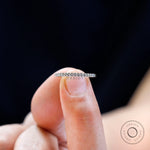 Minimalist pave moissanite wedding band hold on the finger