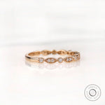 Angled front view marquise and round moissanite pattern wedding band