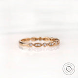 Angled front view marquise and round moissanite pattern wedding band
