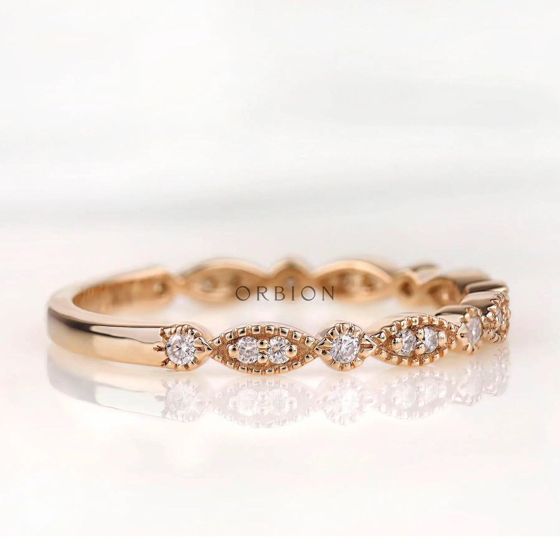 Angled front view marquise and round moissanite pattern wedding band