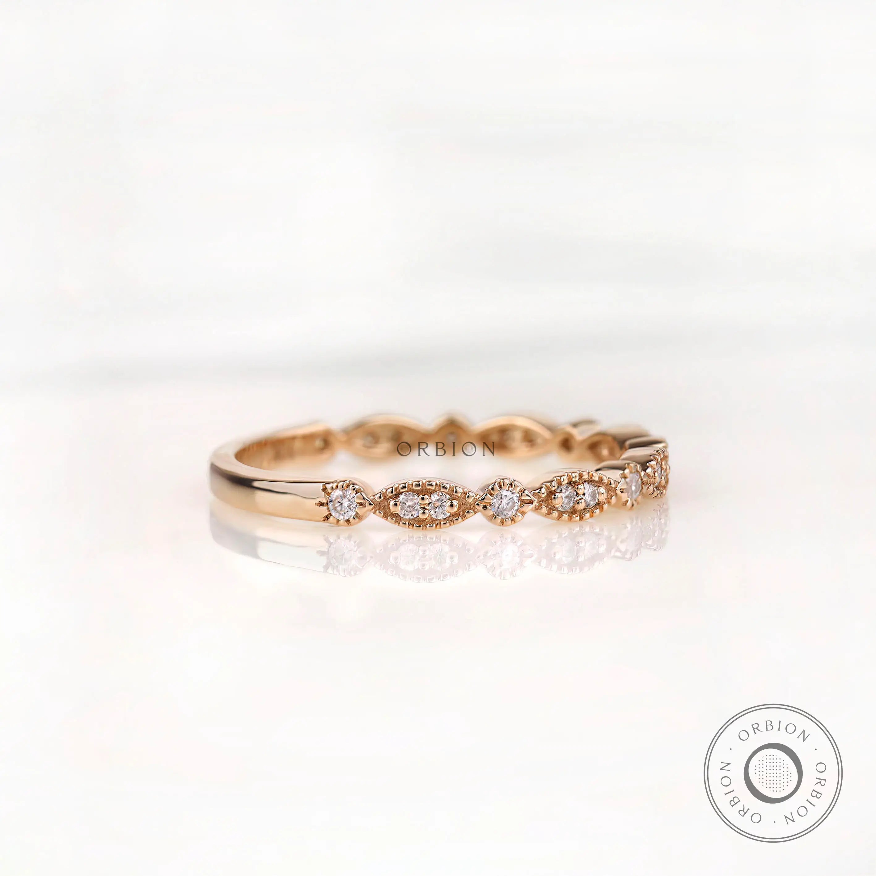 Angled front view marquise and round moissanite pattern wedding band