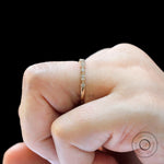 Close-up view of marquise link and round moissanite band highlighting milgrain details