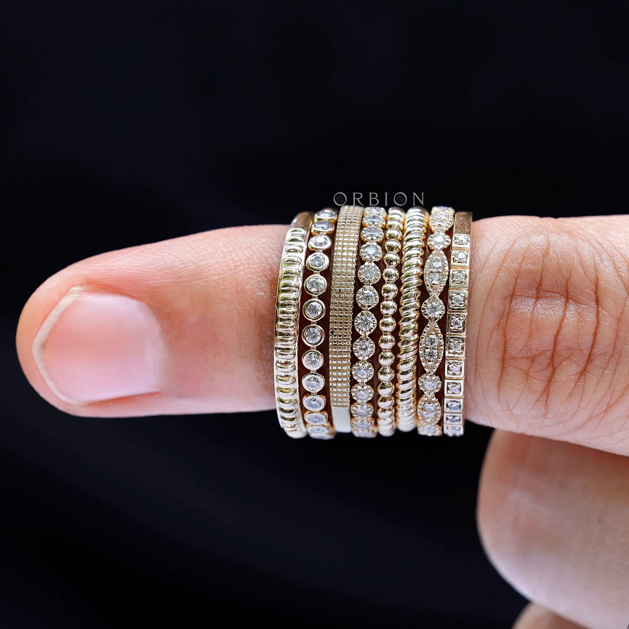 Geometric and textured marquise and round moissanite band styled with stacked wedding rings