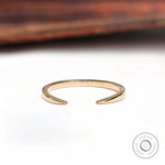 Minimalist open cuff claw wedding band angled view highlighting polished gold finish