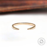 Minimalist open cuff claw wedding band angled view highlighting polished gold finish