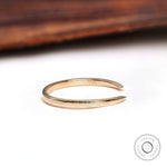 Side profile of solid gold open cuff wedding band showing tapered claw ends