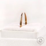 Solid gold open cuff claw band standing view showing slim band thickness