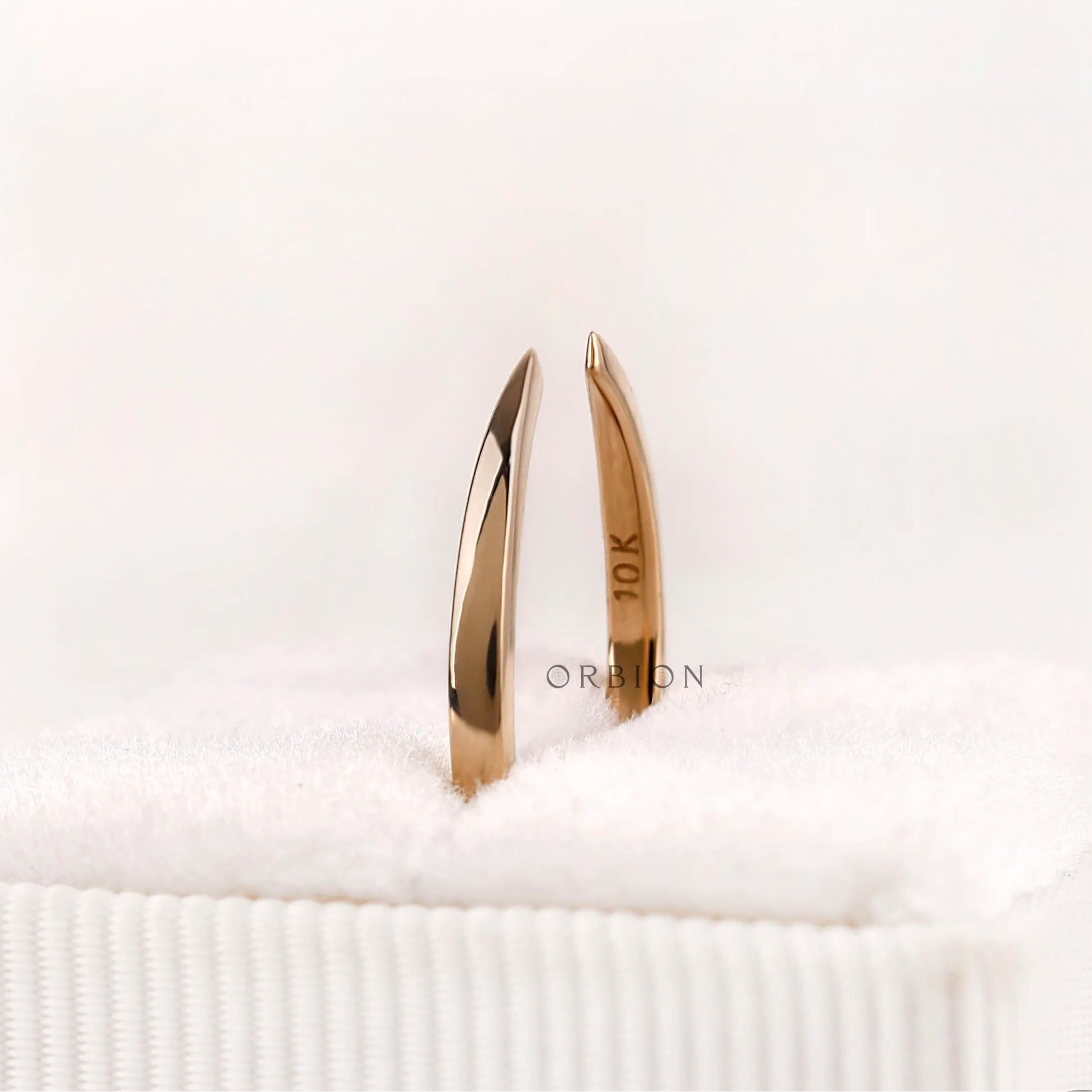 Solid gold open cuff claw band standing view showing slim band thickness