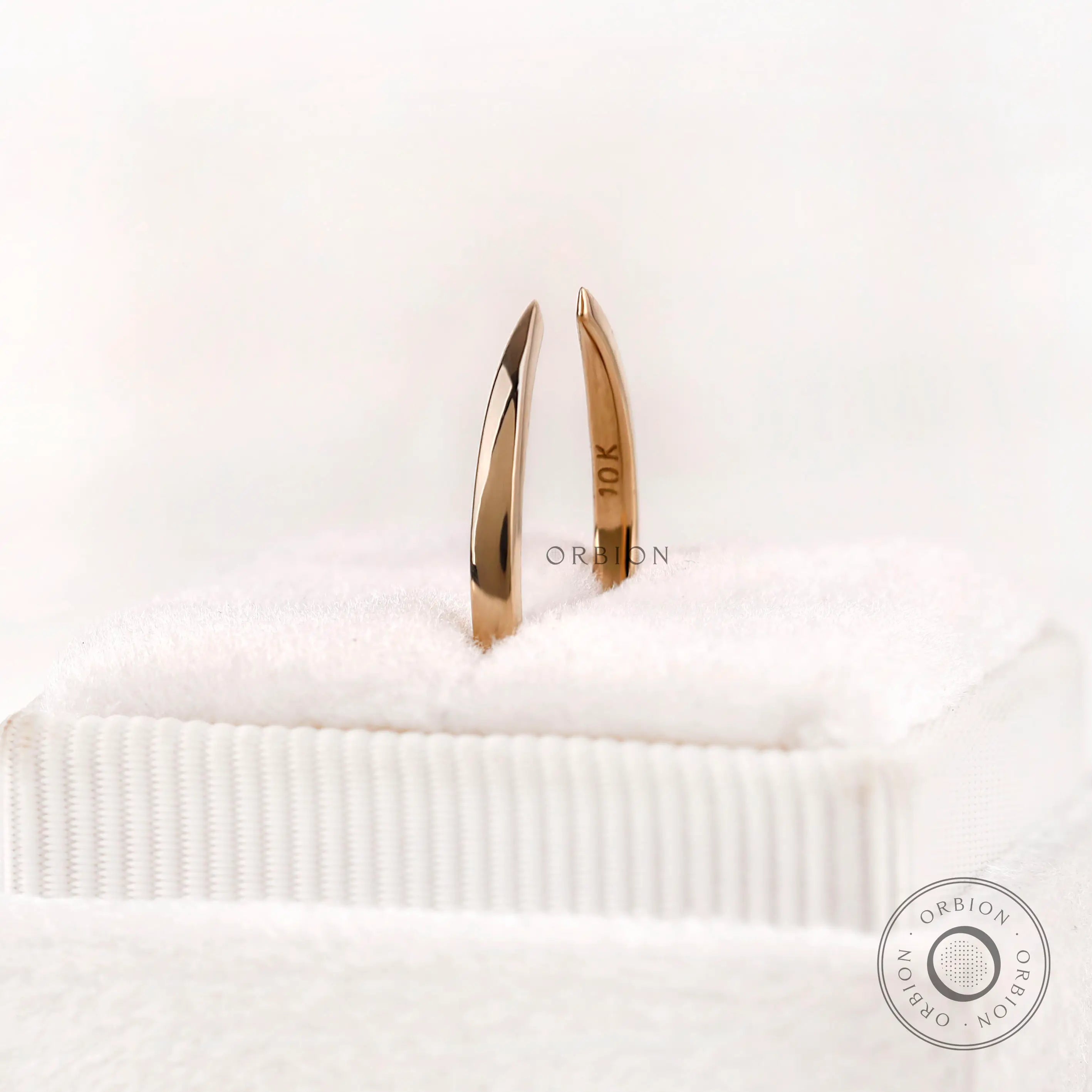 Solid gold open cuff claw band standing view showing slim band thickness