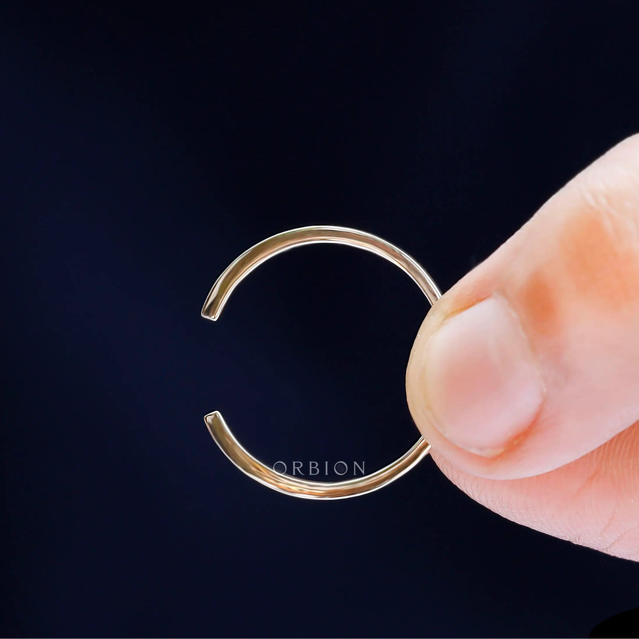 Detailed macro view of solid gold open cuff claw wedding band design