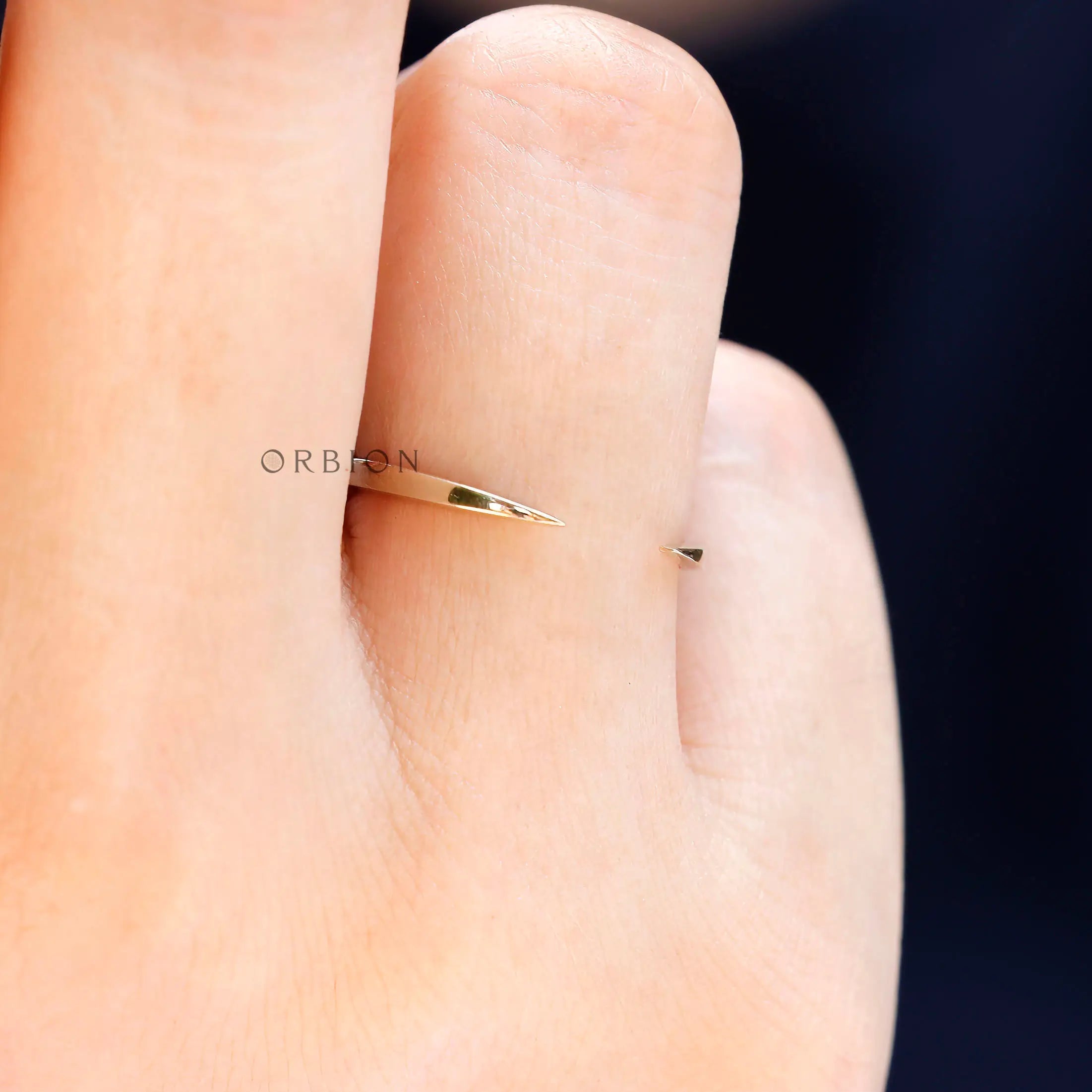 Minimalist gold open cuff band worn on finger for scale and fit reference
