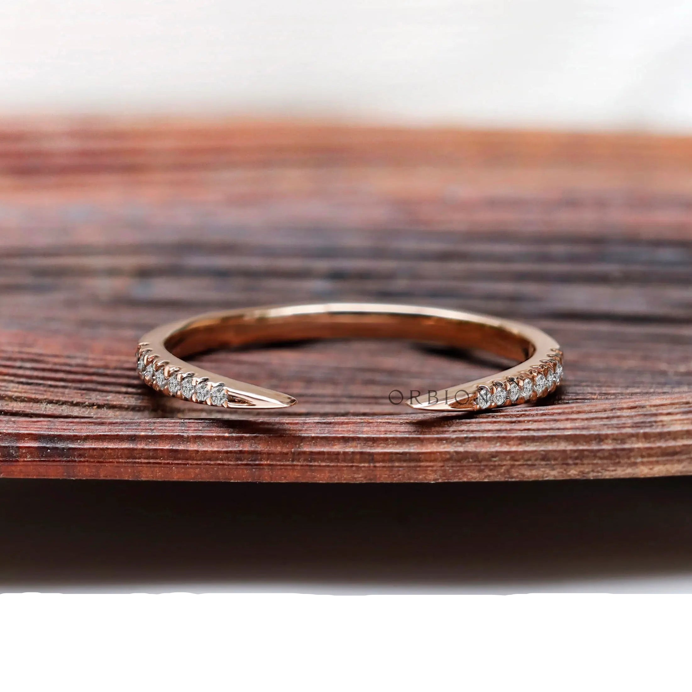 Curved open diamond wedding band in 10k rose gold