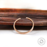 Thin rose gold diamond ring with curved profile