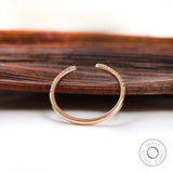 Thin rose gold diamond ring with curved profile