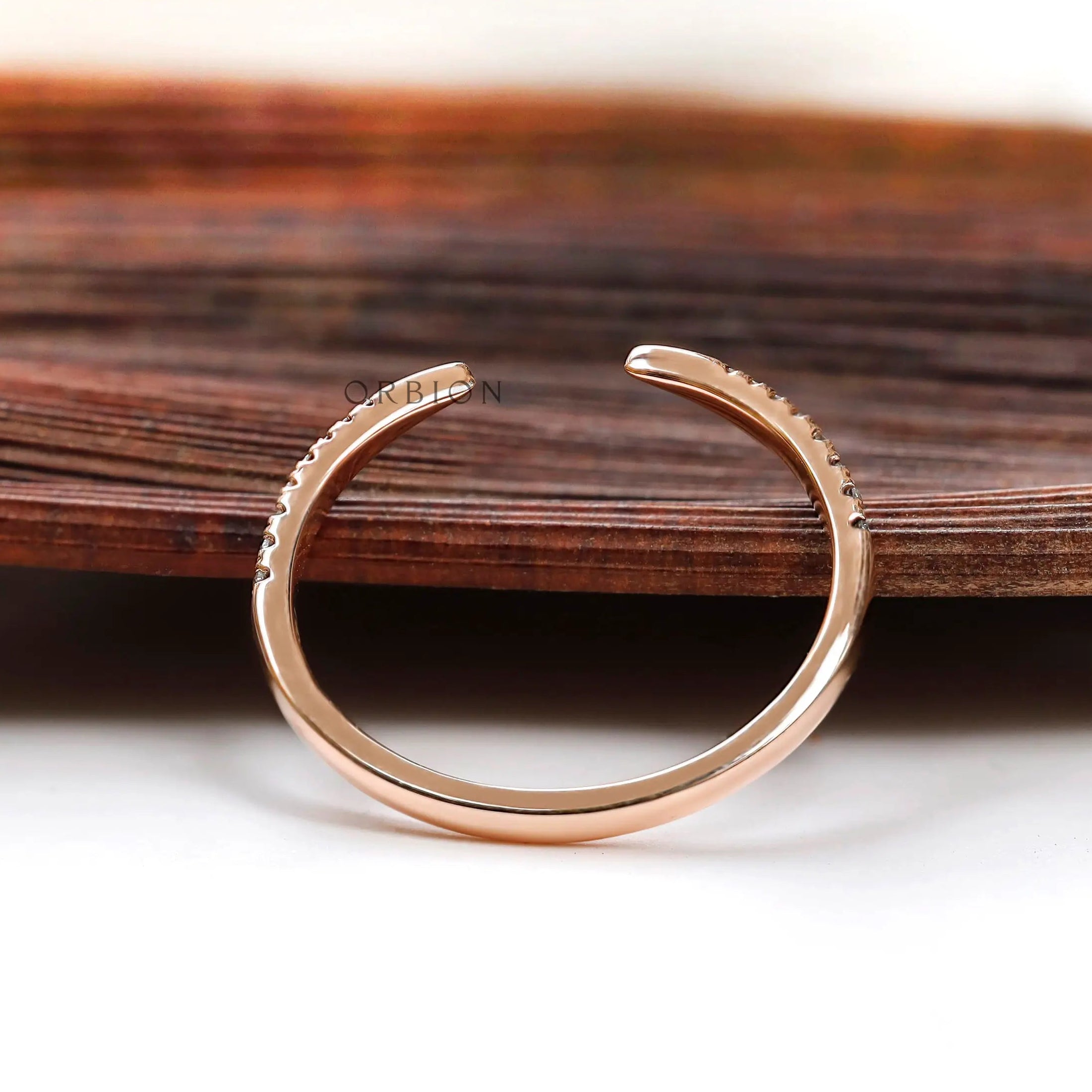 Thin rose gold diamond ring with curved profile
