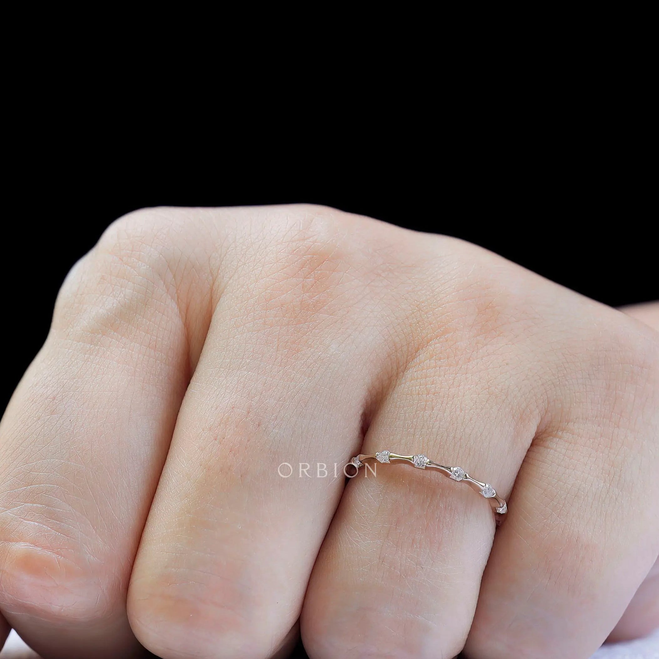 Slim bamboo style moissanite ring worn on hand