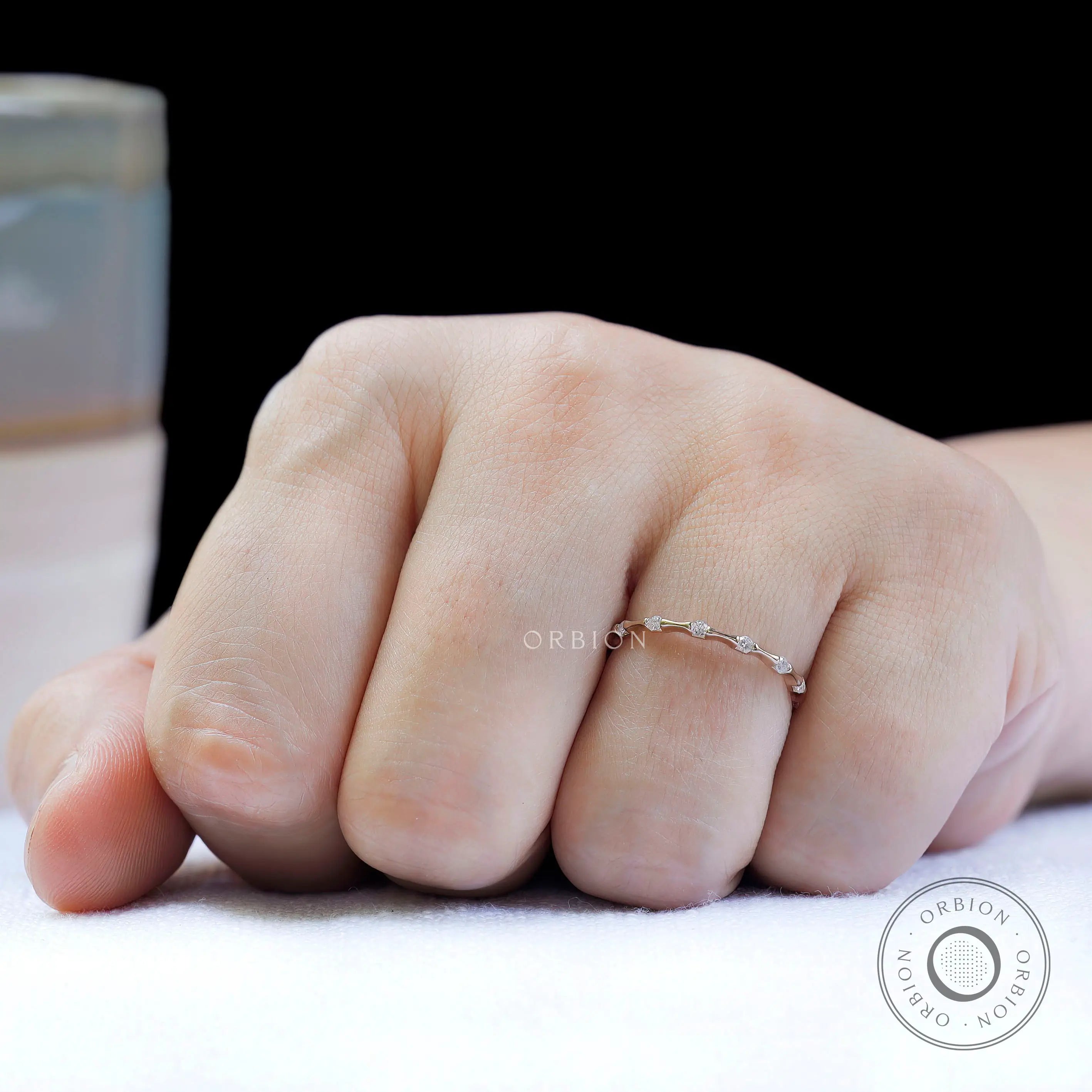 Slim bamboo style moissanite ring worn on hand