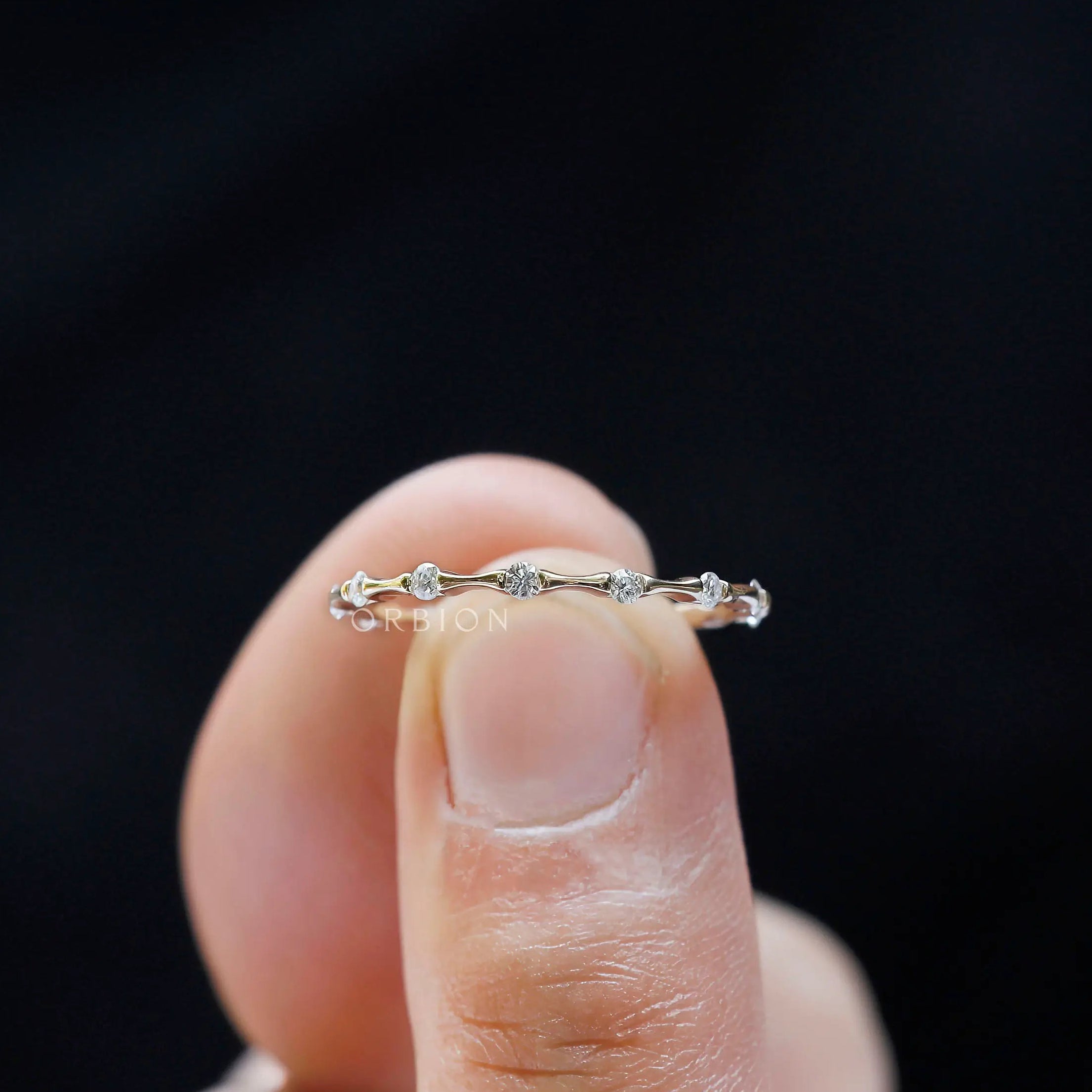 Thin modern bamboo wedding band detailed stone setting