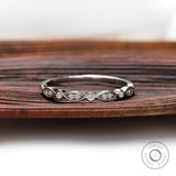 Front view of Art Deco half eternity band with marquise motif and round bezel accents.