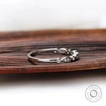 Angled side view of Art Deco inspired wedding band showing alternating marquise bezel-set.