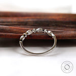 Back view of the half eternity band showing smooth shank and open gallery and the settings.