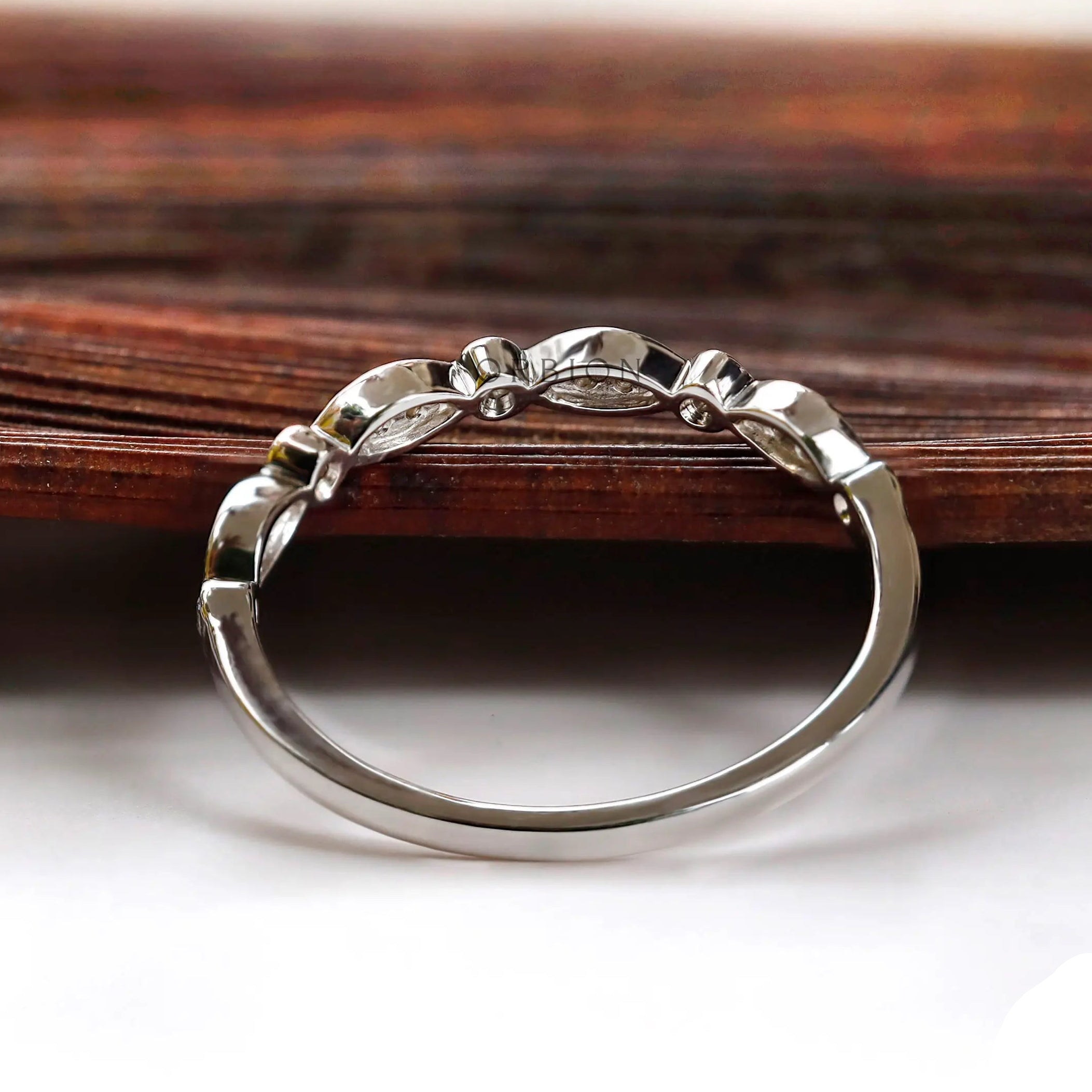 Back view of the half eternity band showing smooth shank and open gallery and the settings.