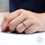 On-hand lifestyle photo of thin Art Deco wedding band with marquise detailing.