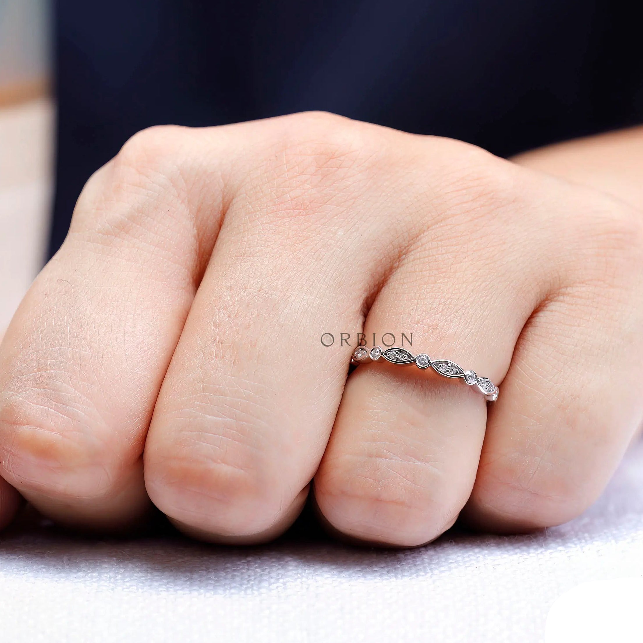 On-hand angle showing the sparkle and pattern of the half eternity band.