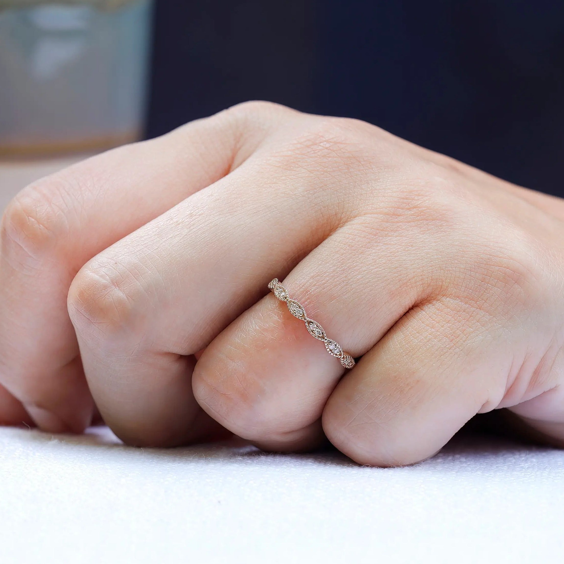 On-hand view of geometric moissanite wedding band