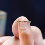 Close-up detail of round moissanite geometric setting