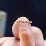 Close-up detail of round moissanite geometric setting