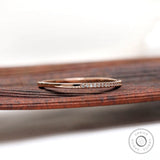 Side angled view of slim pave moissanite diamond stacking band