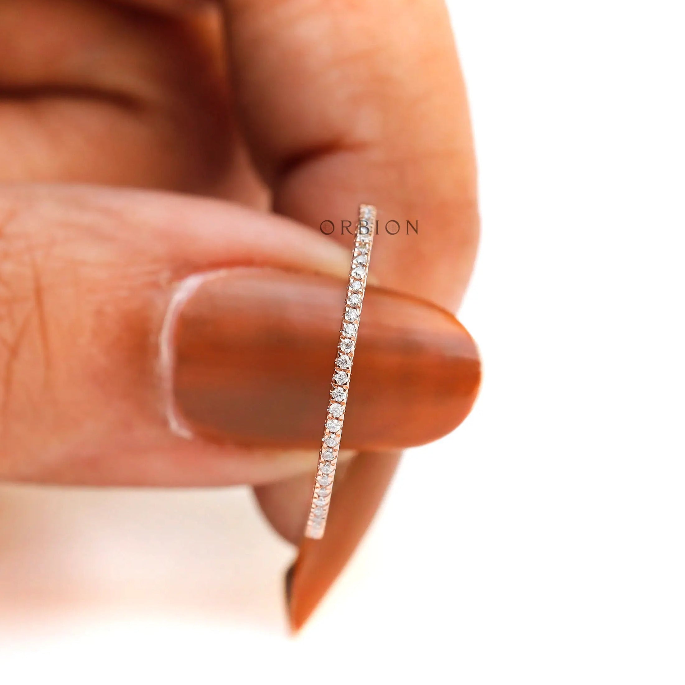 Close-up of pave moissanite stones set along half eternity band